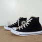 Black converse with a champagne satin like tongue. The tips of the laces match the tongue. Very loved shoe but still usable and in good condition. 